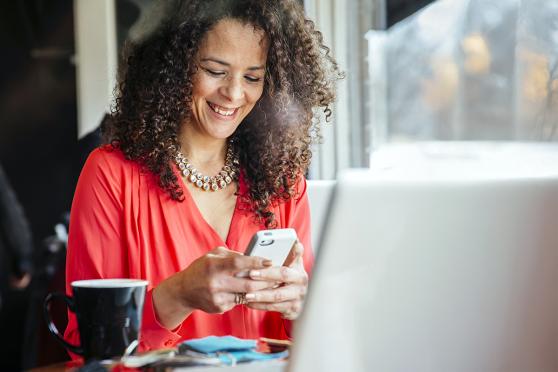 Woman in cafe using smartphone